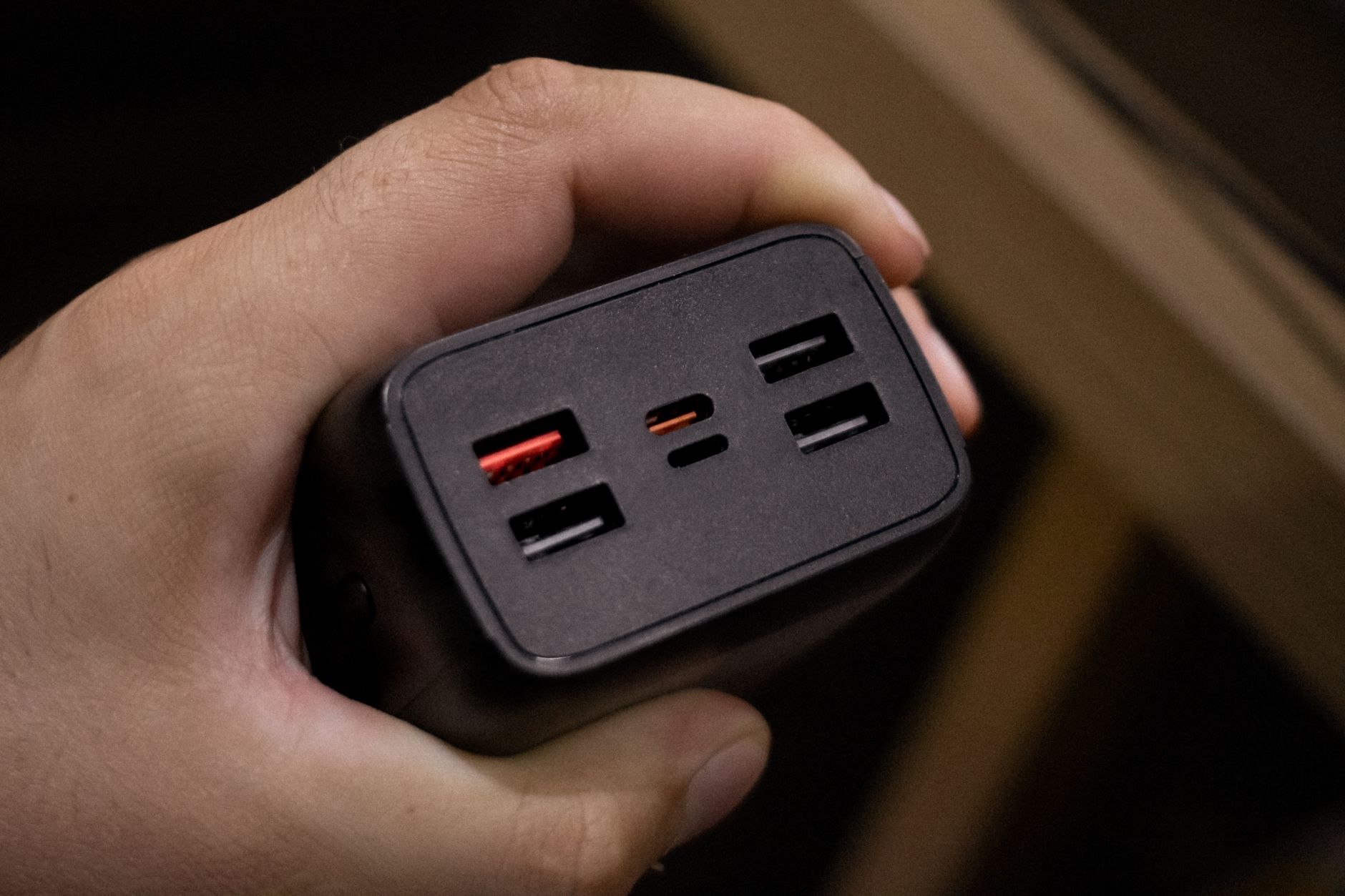 multi-port GaN charger plugged into a clean office desk setup
