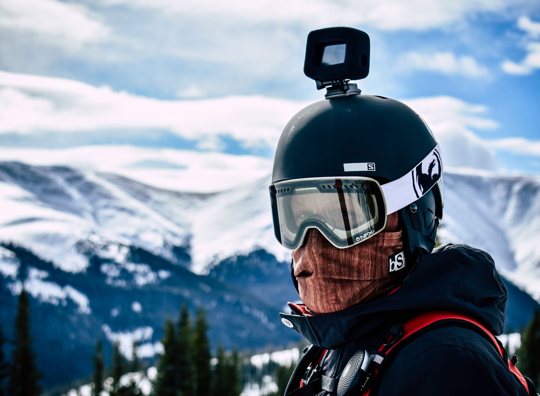 person mounting action camera helmet