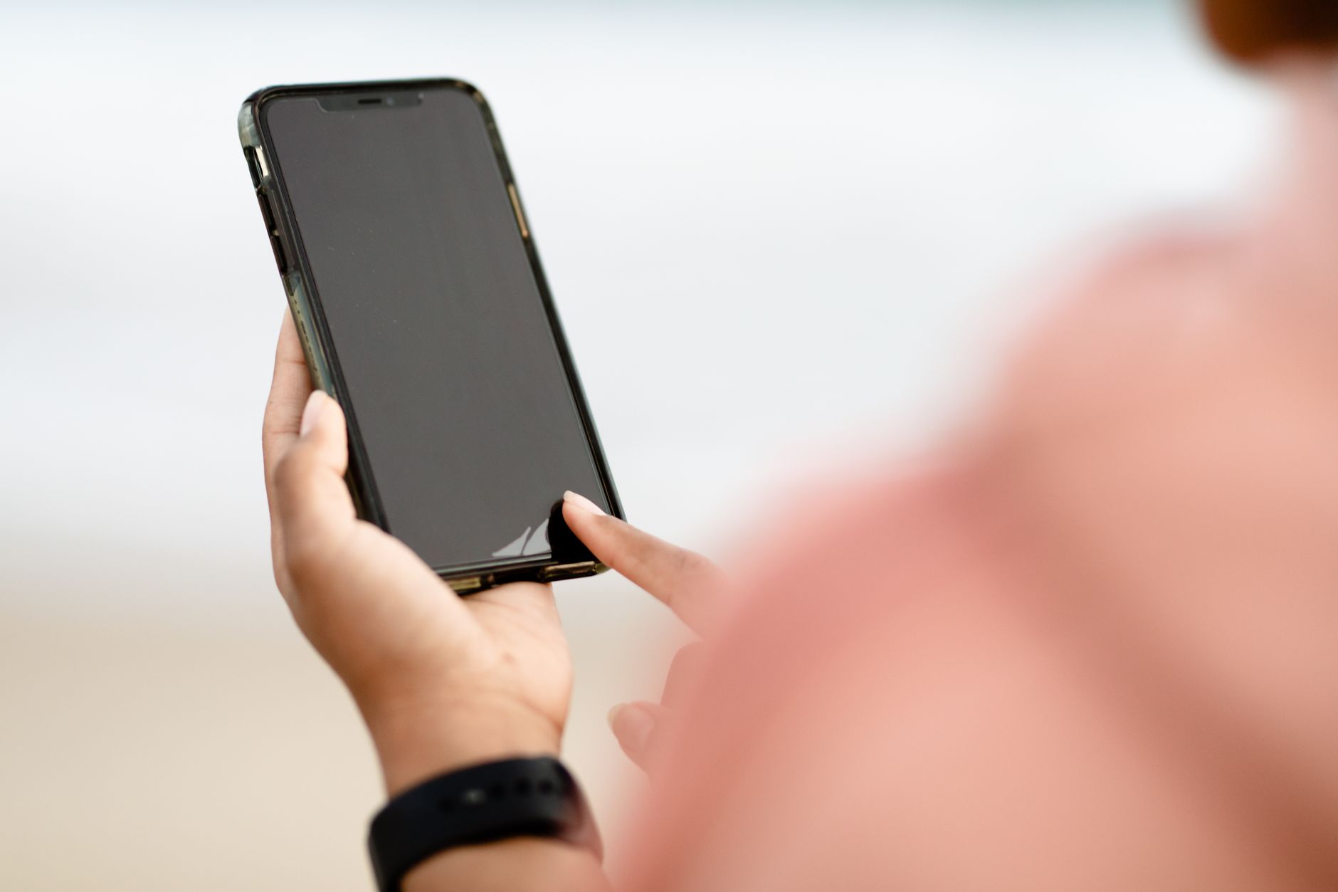 person looking at smartphone screen tech