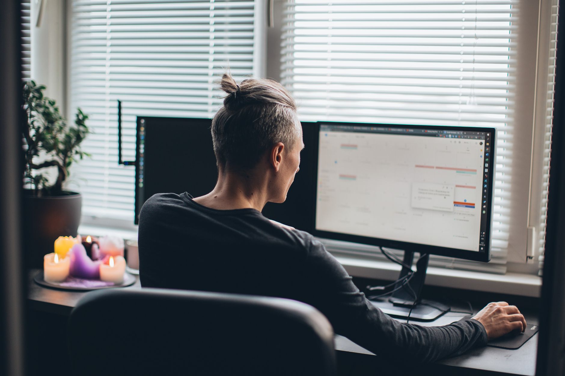 A modern clean home office desk setup featuring a large dual-monitor arrangement and laptop connected via single USB-C cable.