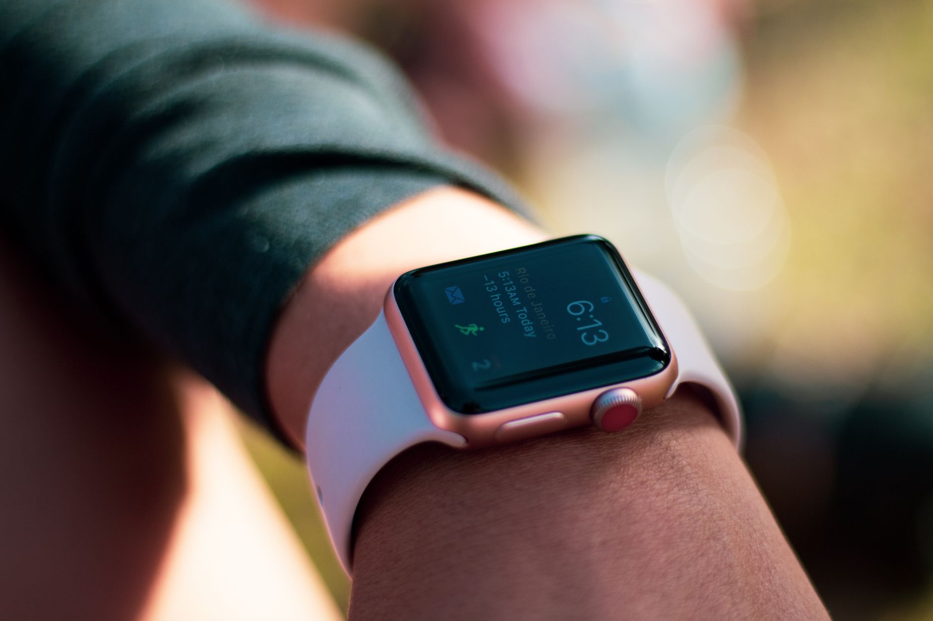 A person looking closely at their Apple Watch screen to check the connection status icon