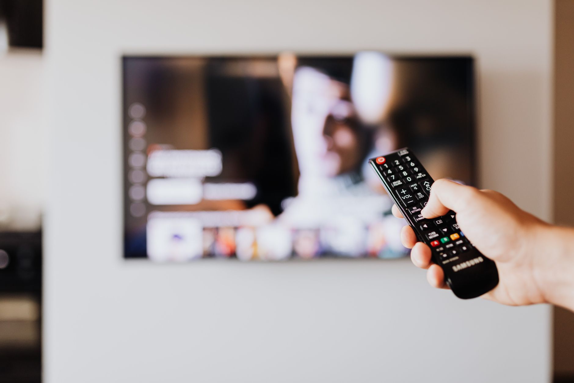 Person troubleshooting smart tv connection issues in a living room