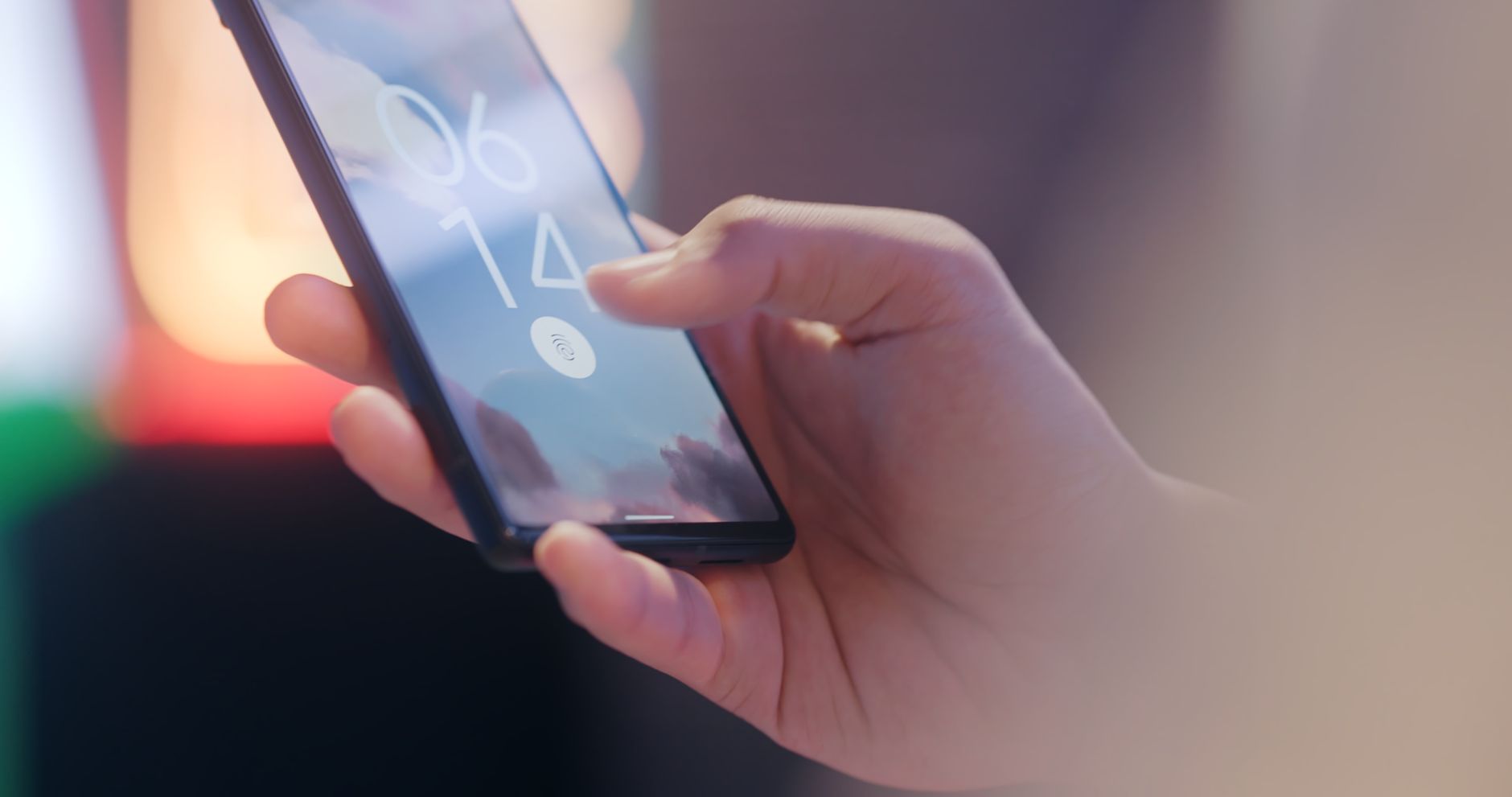 A person using Face ID on a smartphone to authenticate a passkey login on a screen