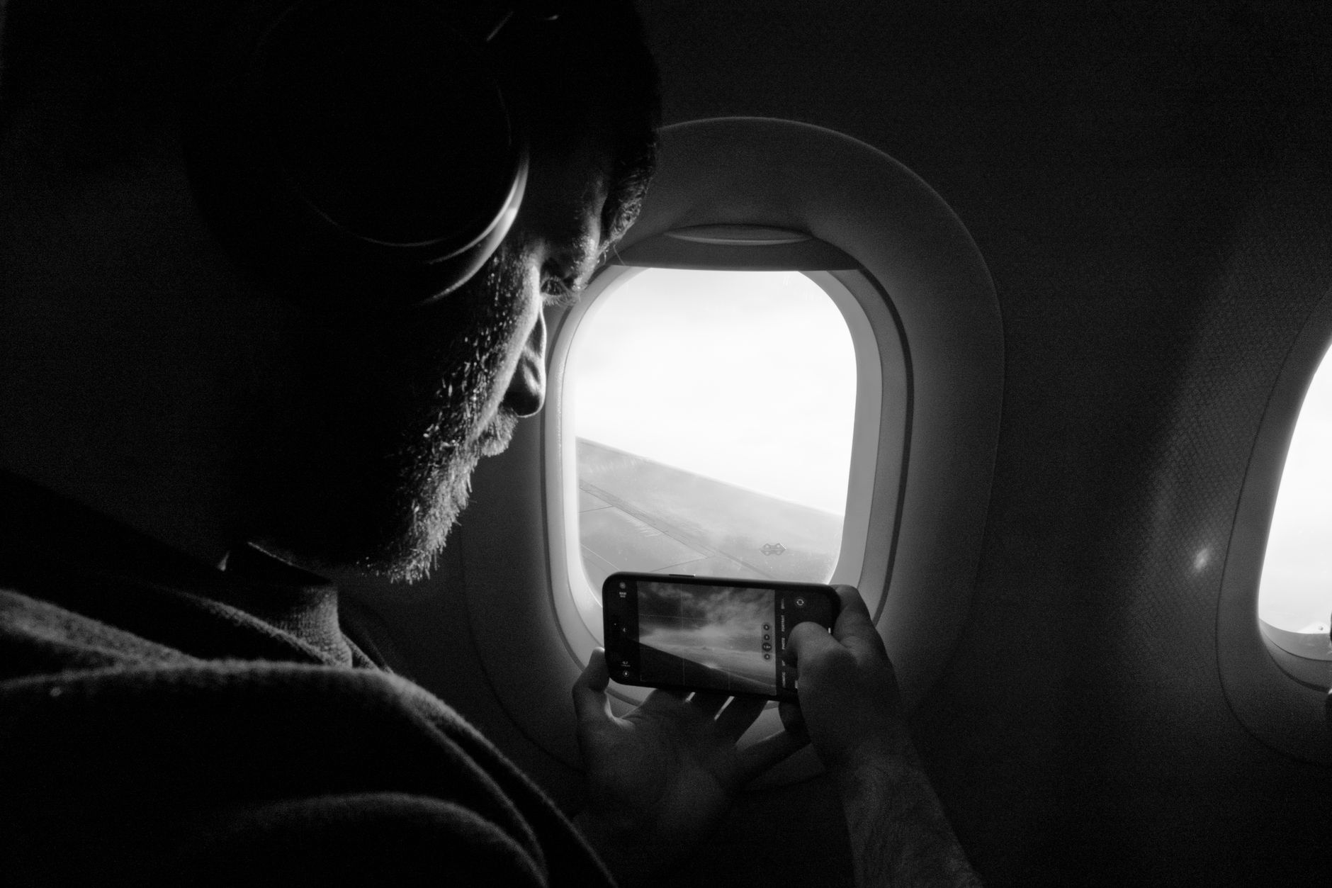 traveler listening over-ear headphones airplane